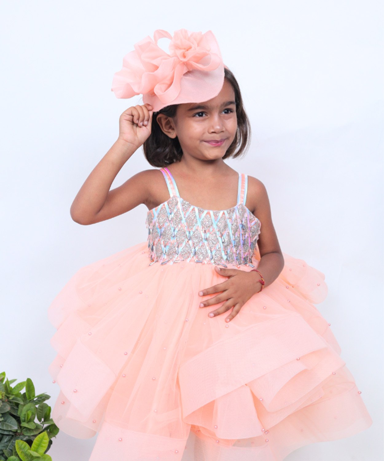 Peach Frock With Sequined Bodice, Layered Skirt, And Matching Ruffled Headpiece.