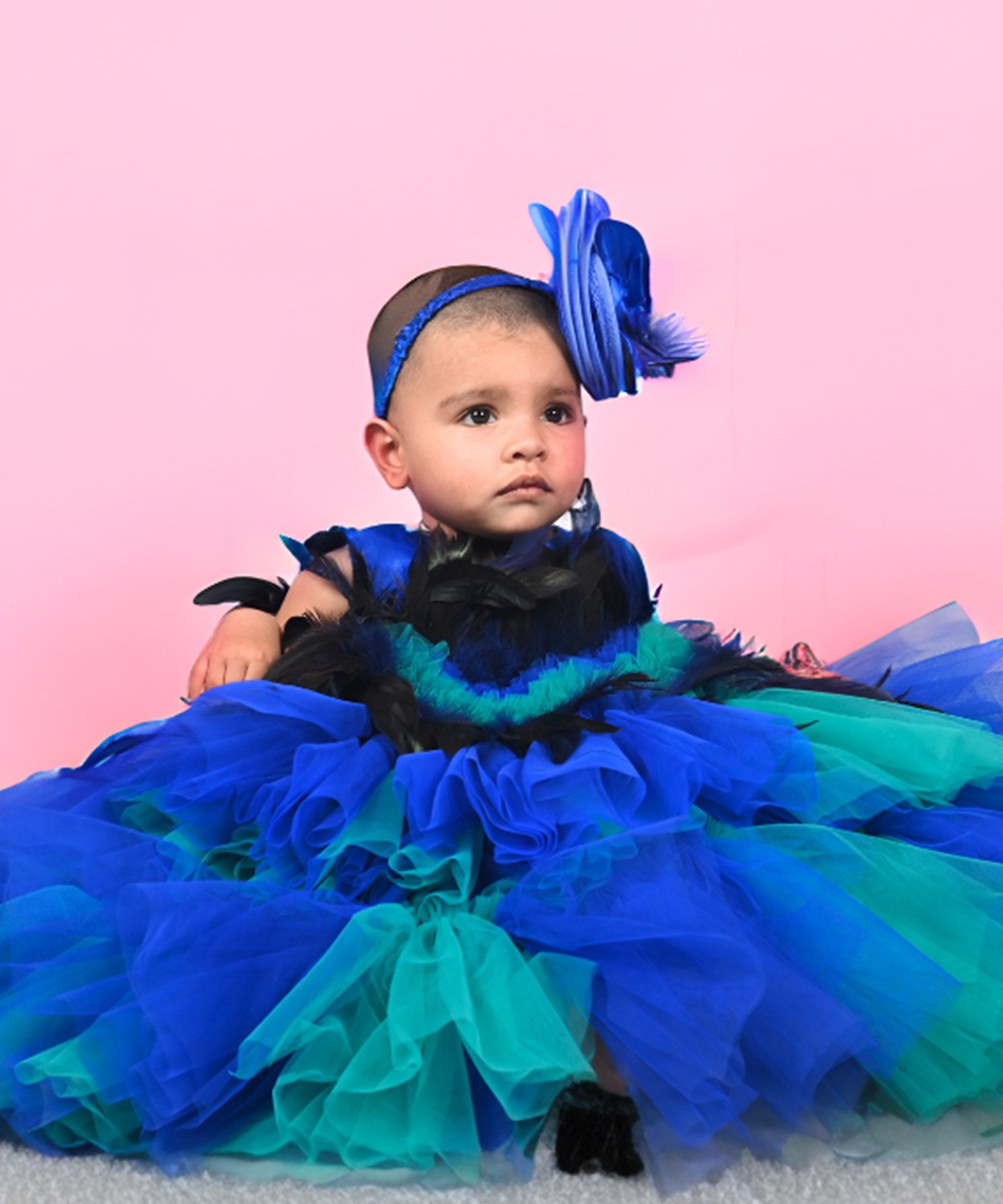 Vibrant Blue And Green Layered Dress With Feather Accents And Matching Headband